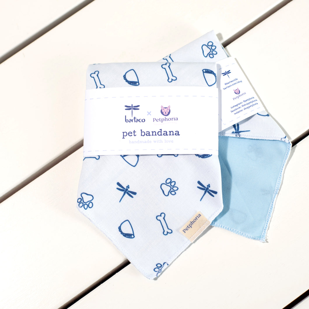 Two white bandanas with dark blue illustrations on a white table top.
